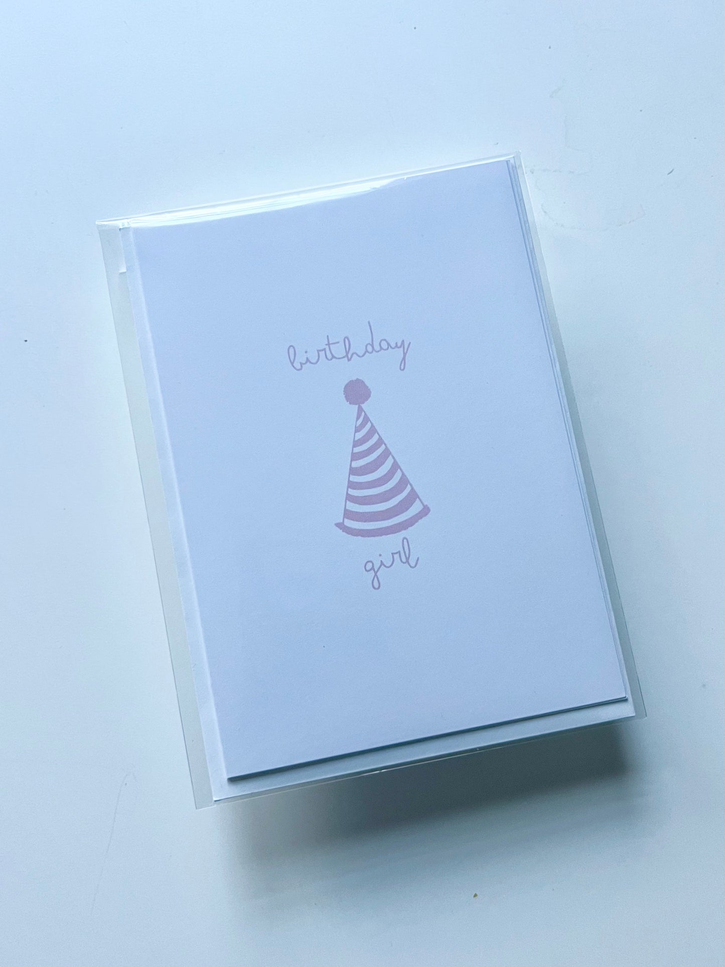 hand drawn happy birthday greeting card with pink party hat that says birthday girl.
