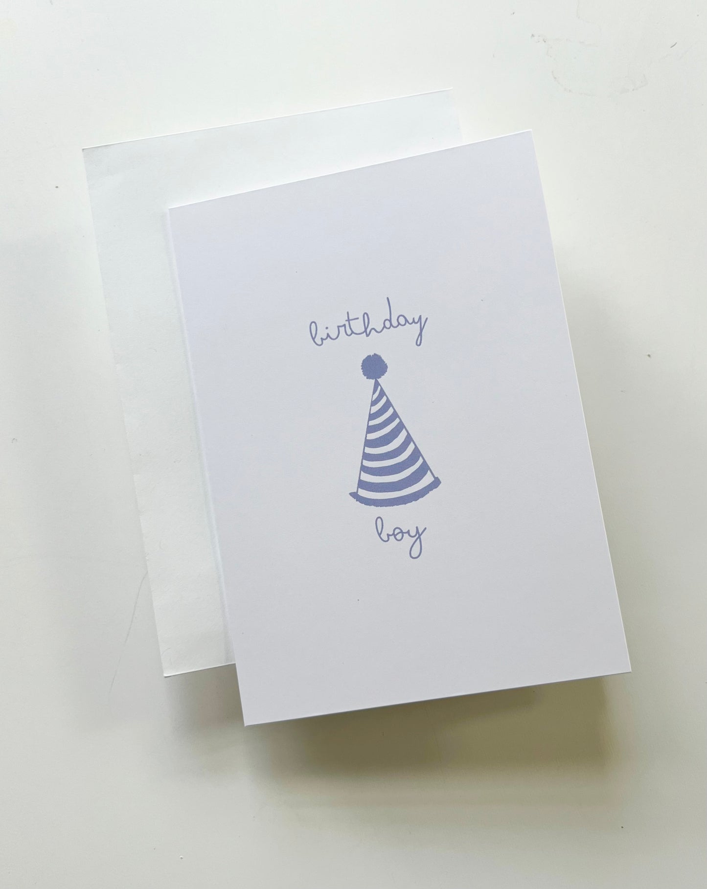 hand drawn happy birthday greeting card with blue party hat that says birthday boy.