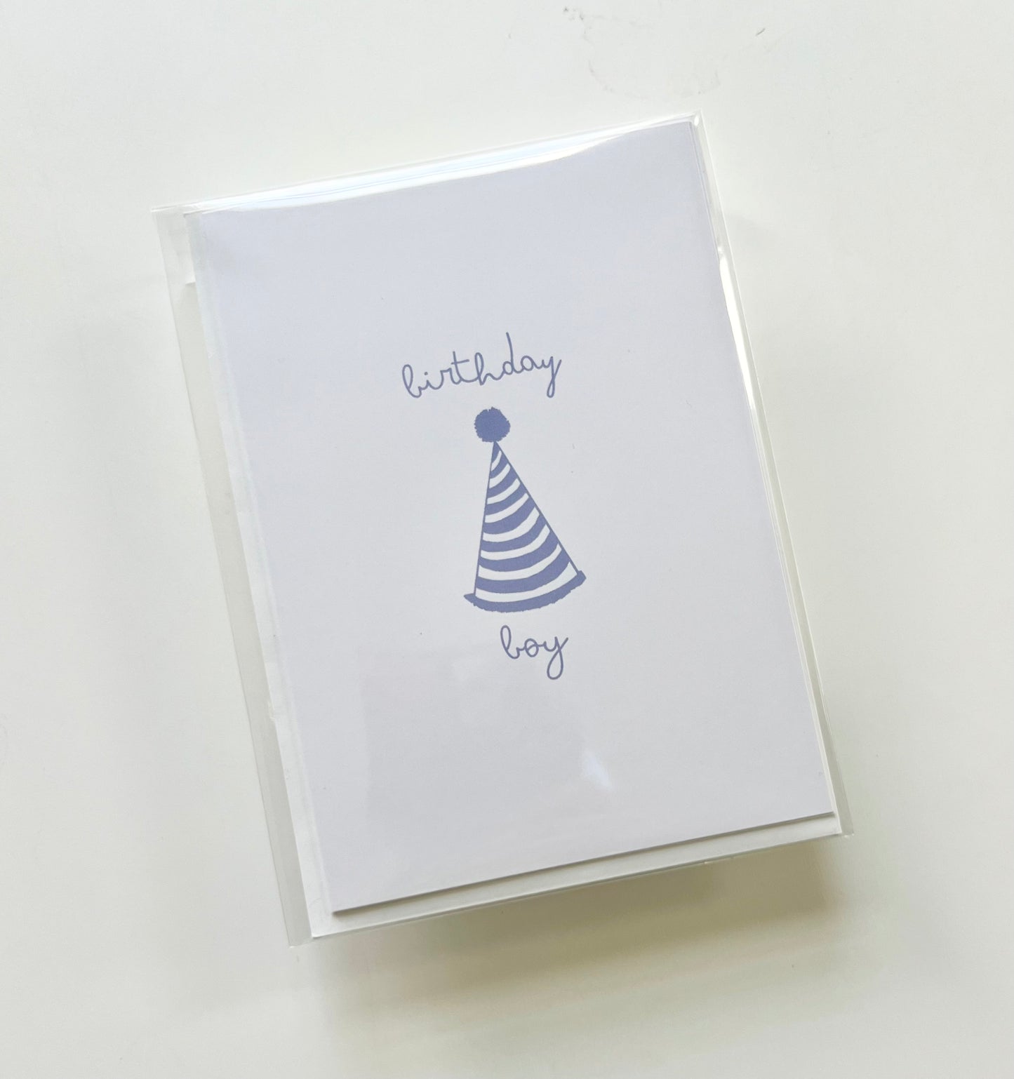 hand drawn happy birthday greeting card with blue party hat that says birthday boy.