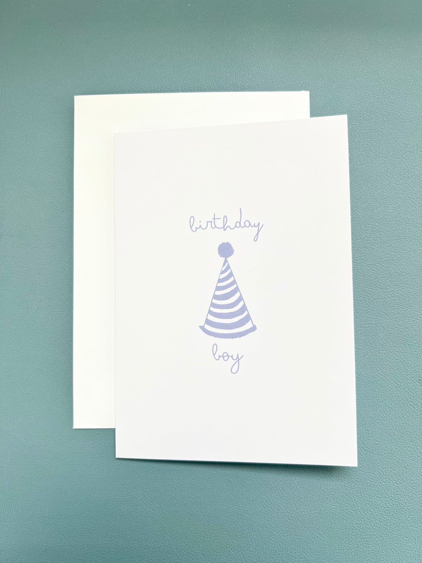 hand drawn happy birthday greeting card with blue party hat that says birthday boy.
