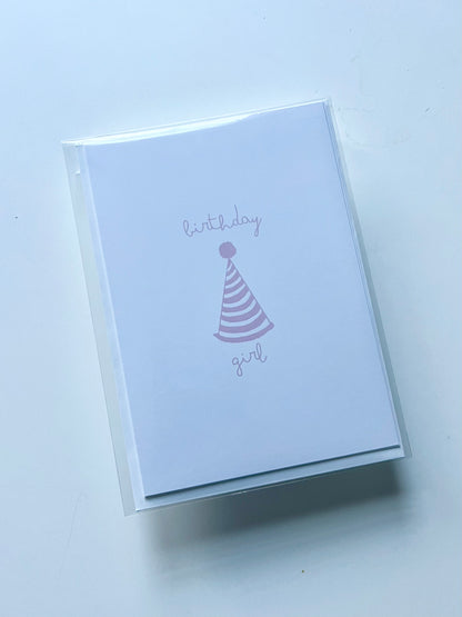 hand drawn happy birthday greeting card with pink party hat that says birthday girl.