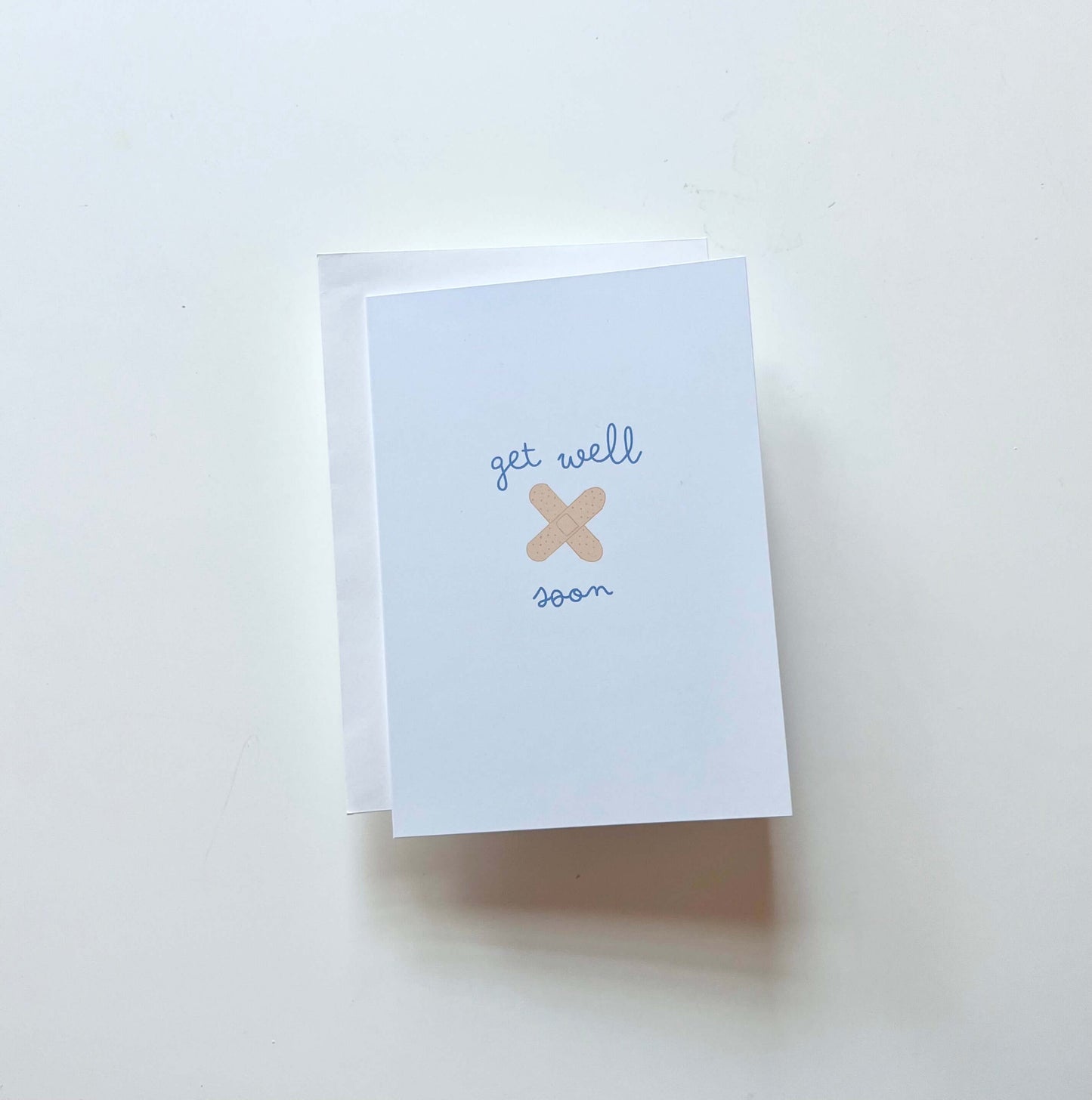 hand drawn blue get well soon greeting card with you crossed bandaids.