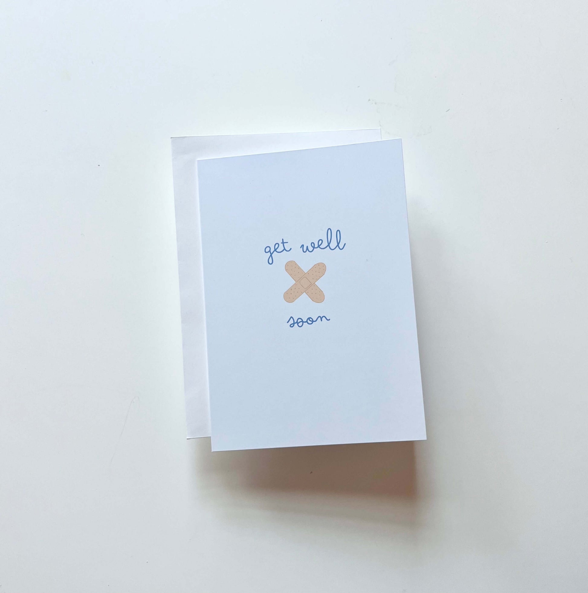 hand drawn blue get well soon greeting card with you crossed bandaids.