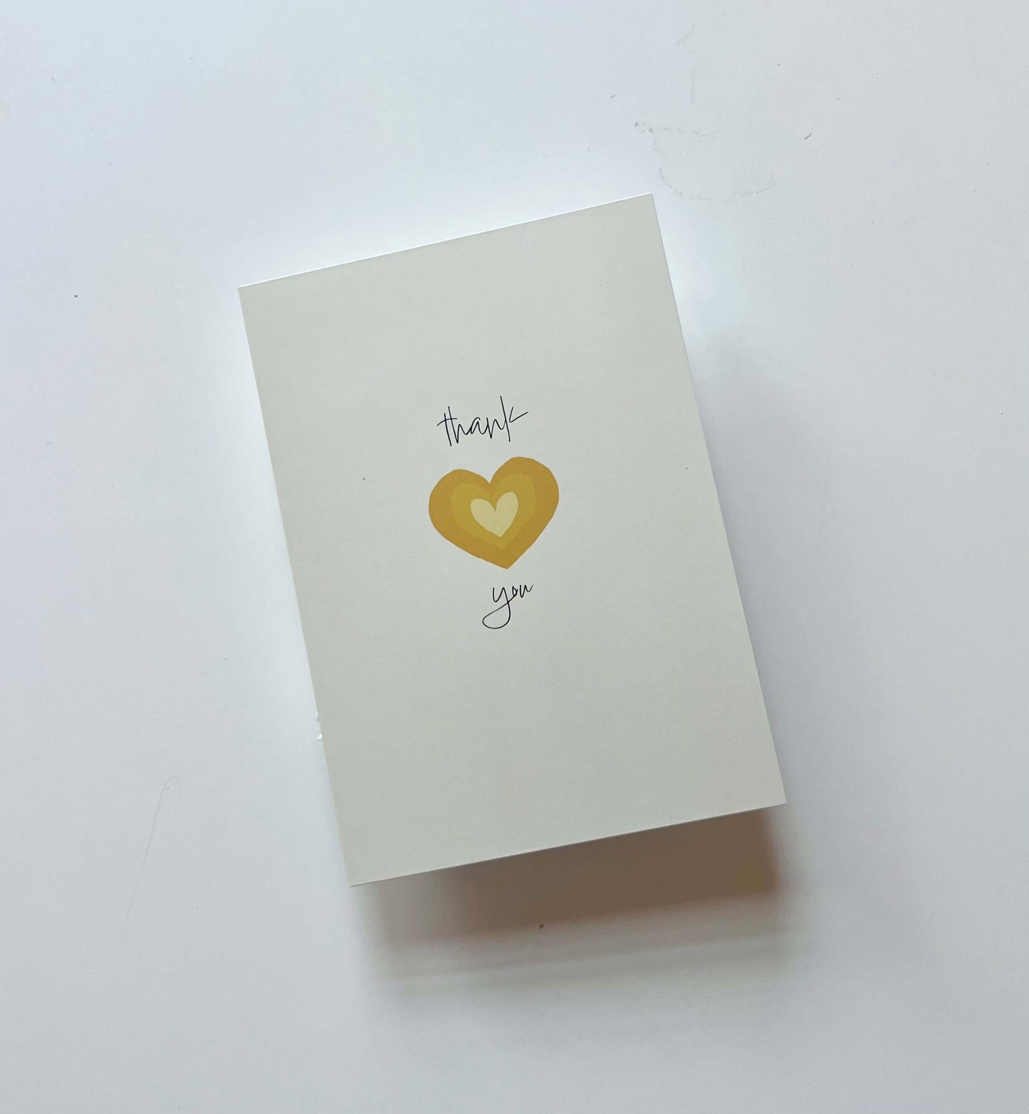 hand drawn yellow heart greeting card that says thank you in cursive.