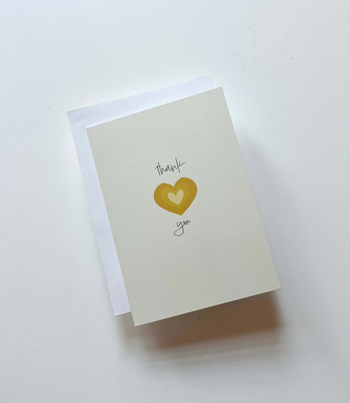 hand drawn yellow heart greeting card that says thank you in cursive.