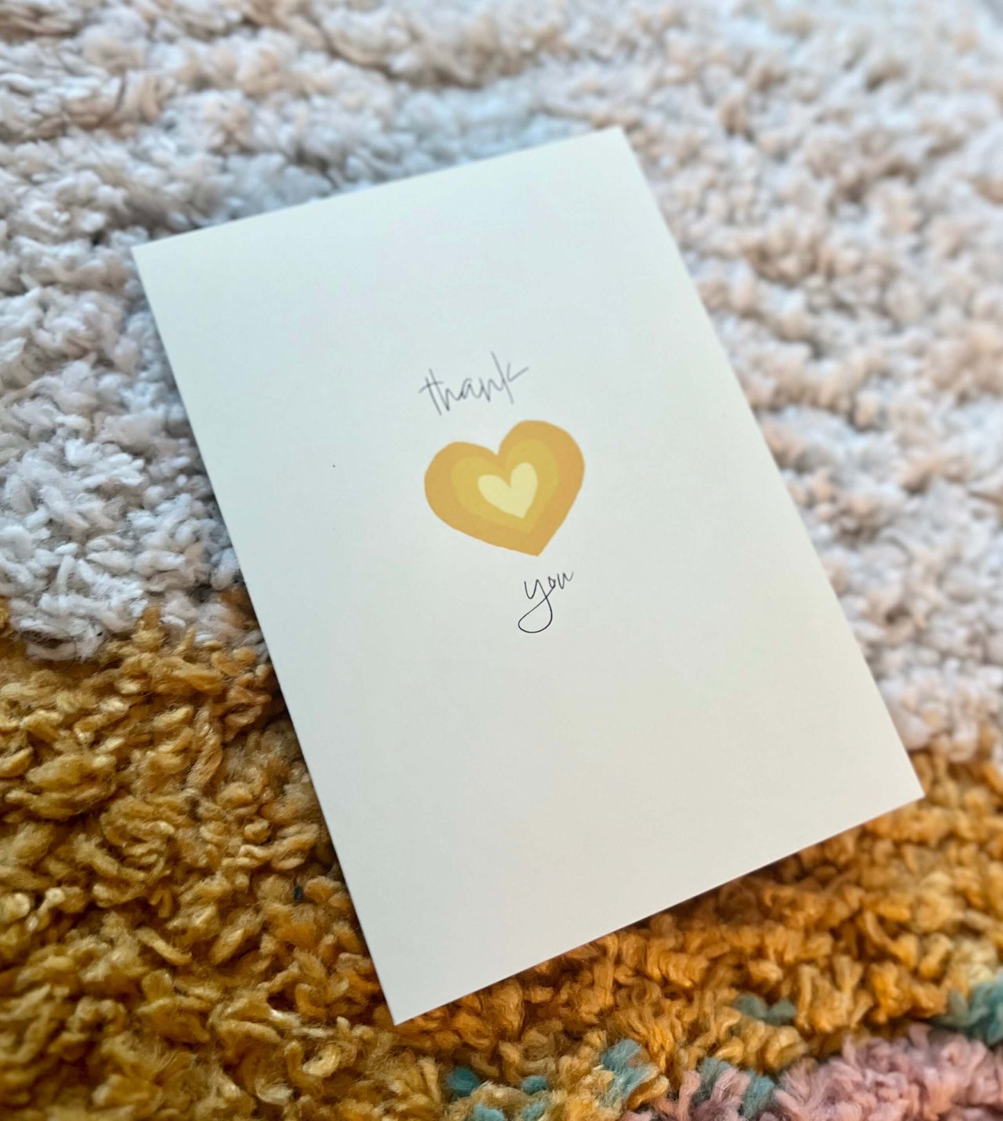 hand drawn yellow heart greeting card that says thank you in cursive.