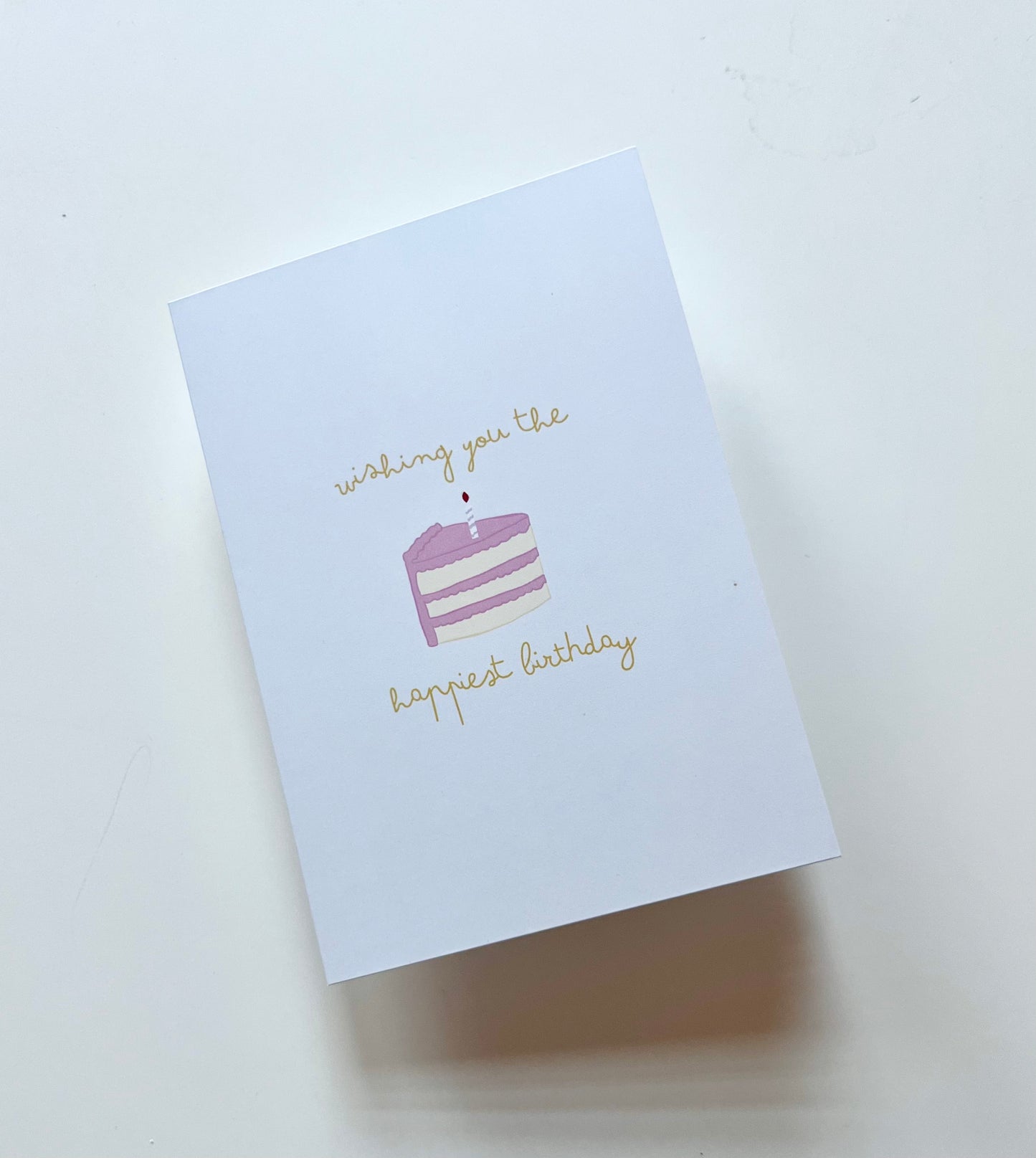 hand drawn greeting card with a piece of cake that says wishing you the happiest birthday.