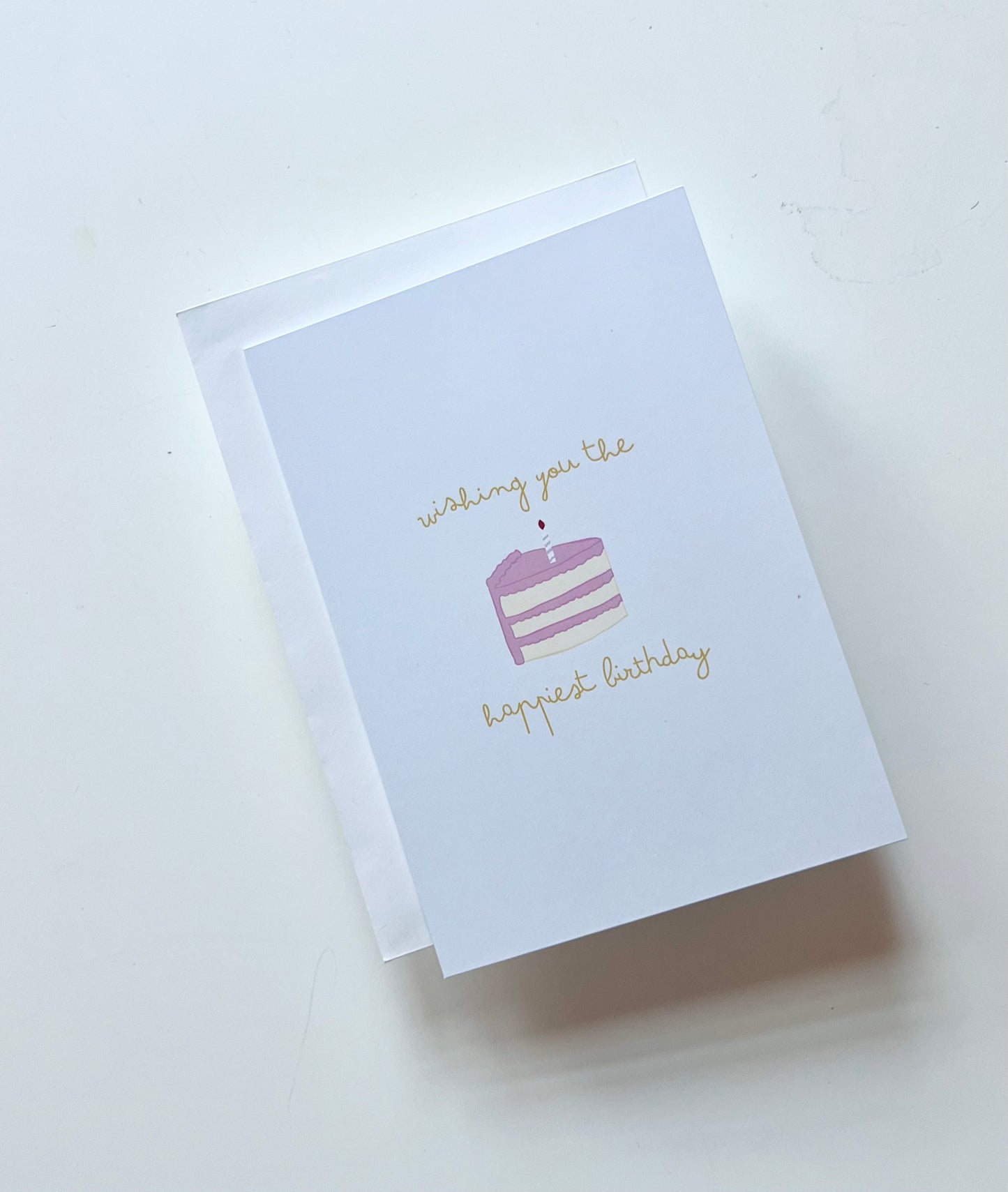 hand drawn greeting card with a piece of cake that says wishing you the happiest birthday.