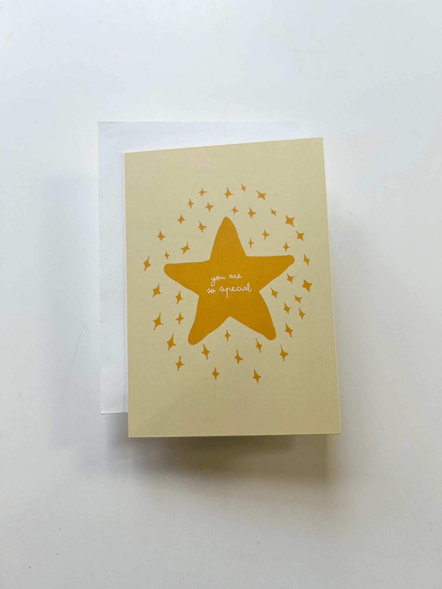 Yellow greeting card with a star design and "you are so special" text, blank inside, wrapped in a white envelope.