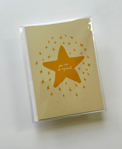 Yellow greeting card featuring a star design with the text "you are so special," wrapped in a clear plastic sleeve.