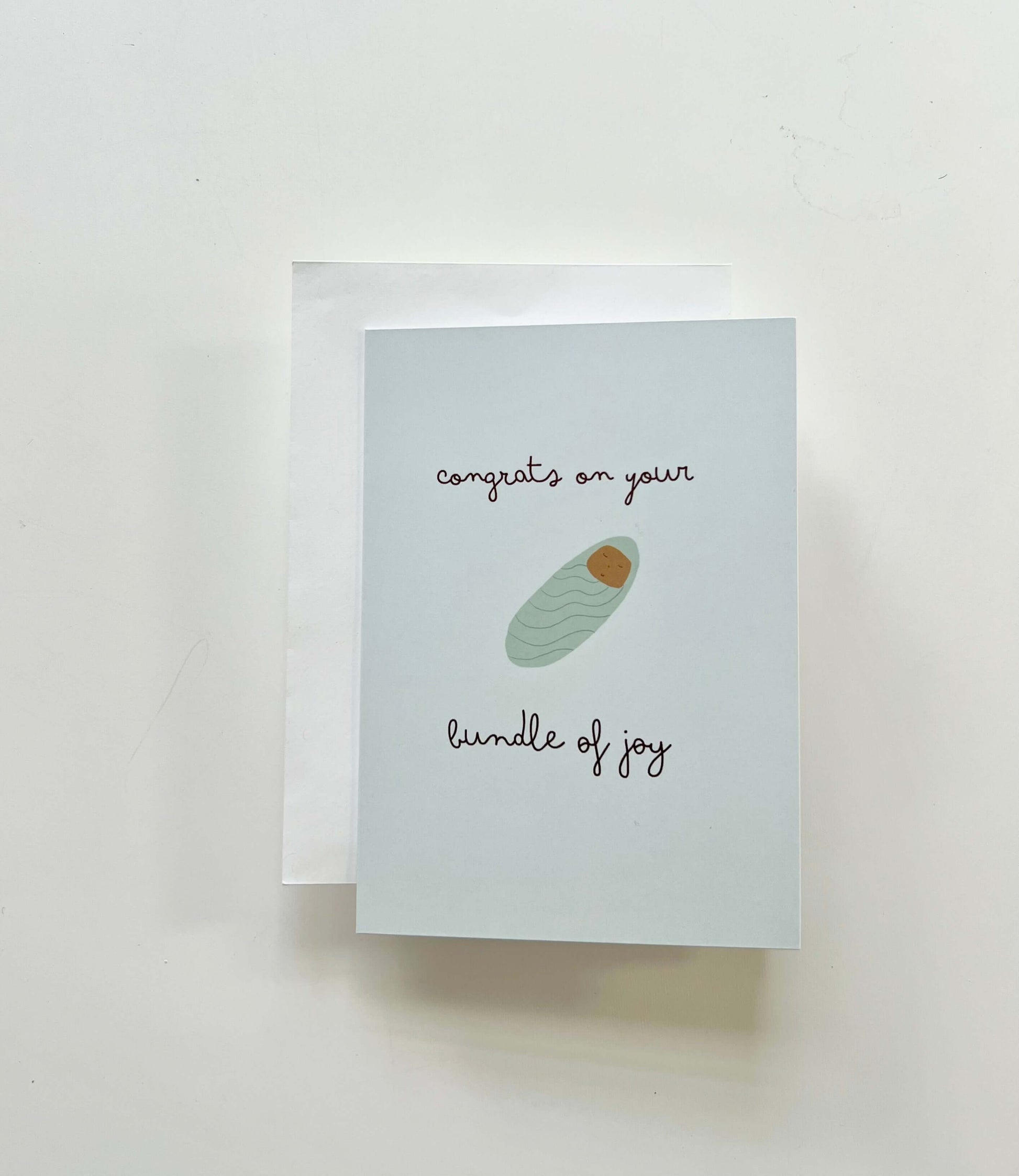 hand drawn green new baby greeting card that says congrats on your bundle of joy.