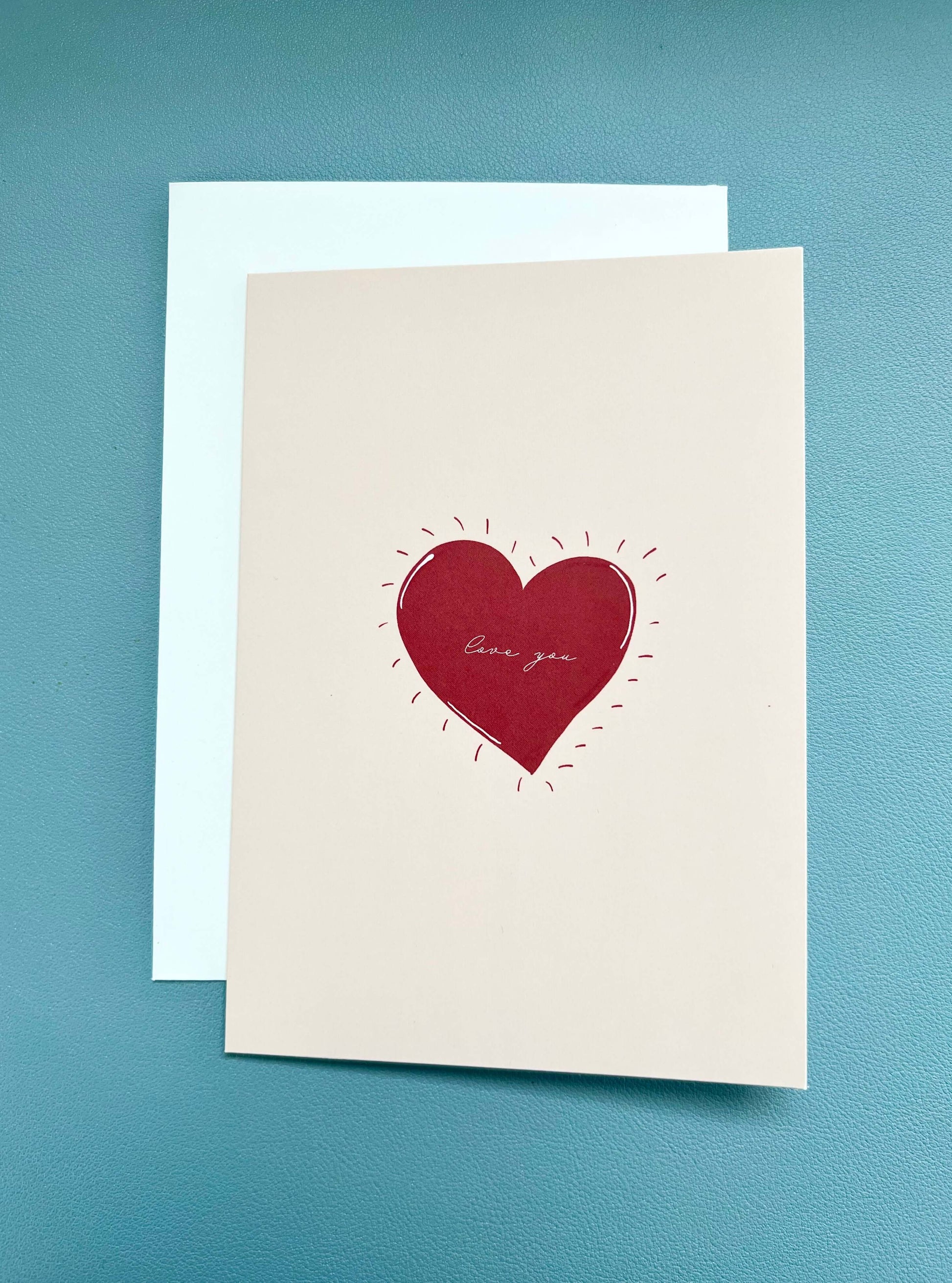 hand drawn valentine's anniversary love greeting card with a red heart that says love you.