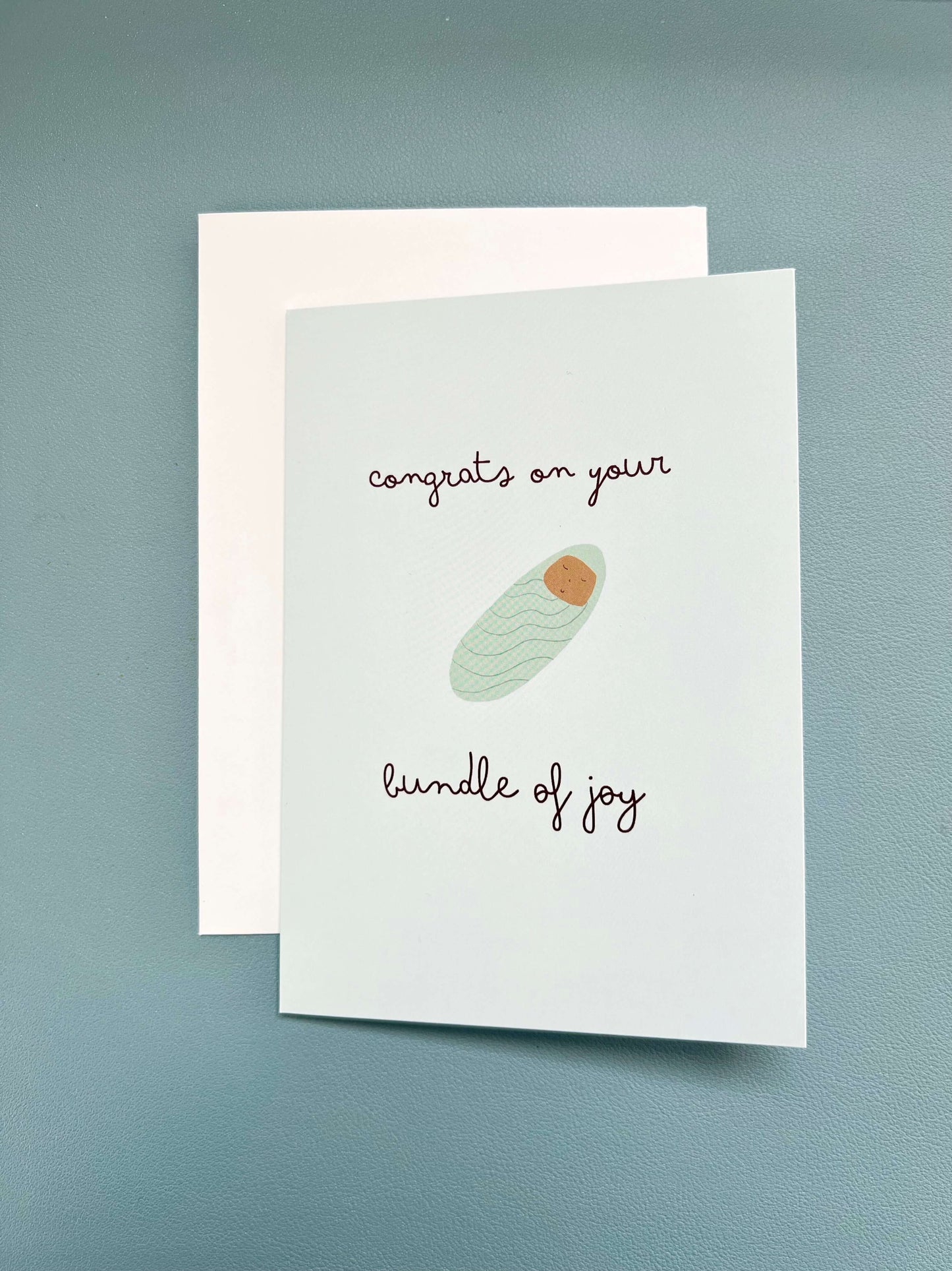 hand drawn green new baby greeting card that says congrats on your bundle of joy.