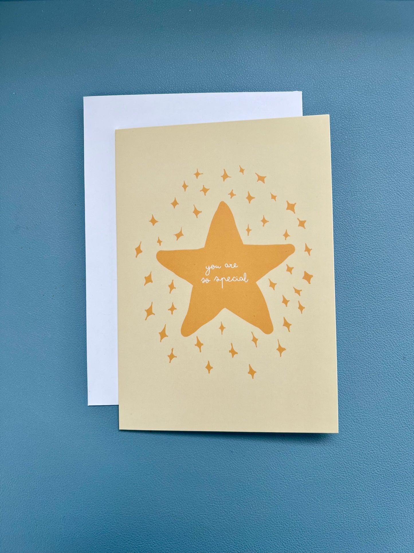 Yellow greeting card with a star design and "you are so special" text, featuring a white envelope.