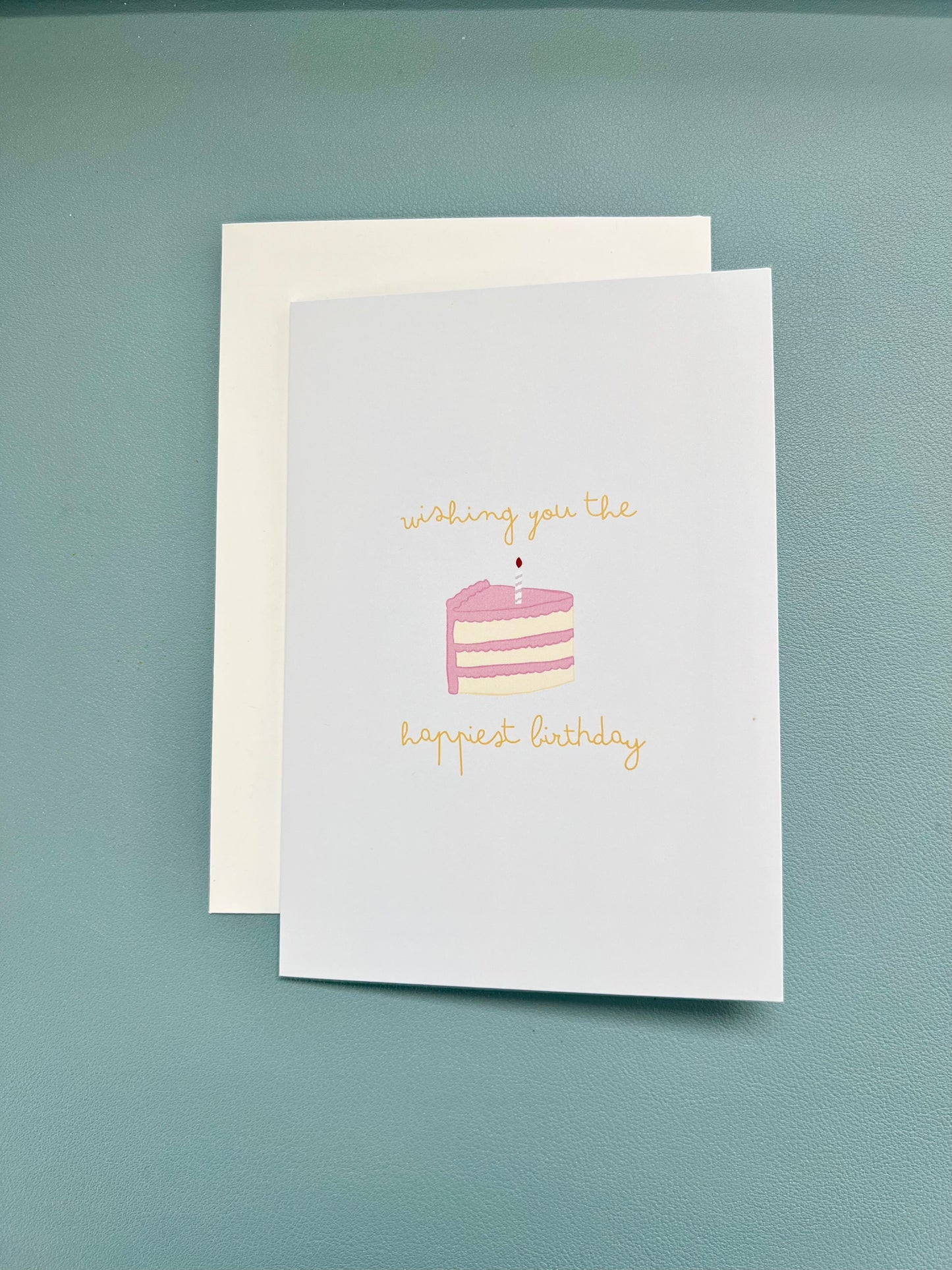 hand drawn greeting card with a piece of cake that says wishing you the happiest birthday.